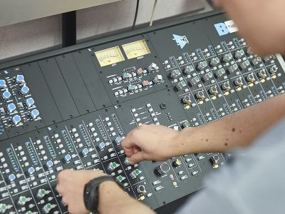 An Electronic & Produced Music student working in a studio